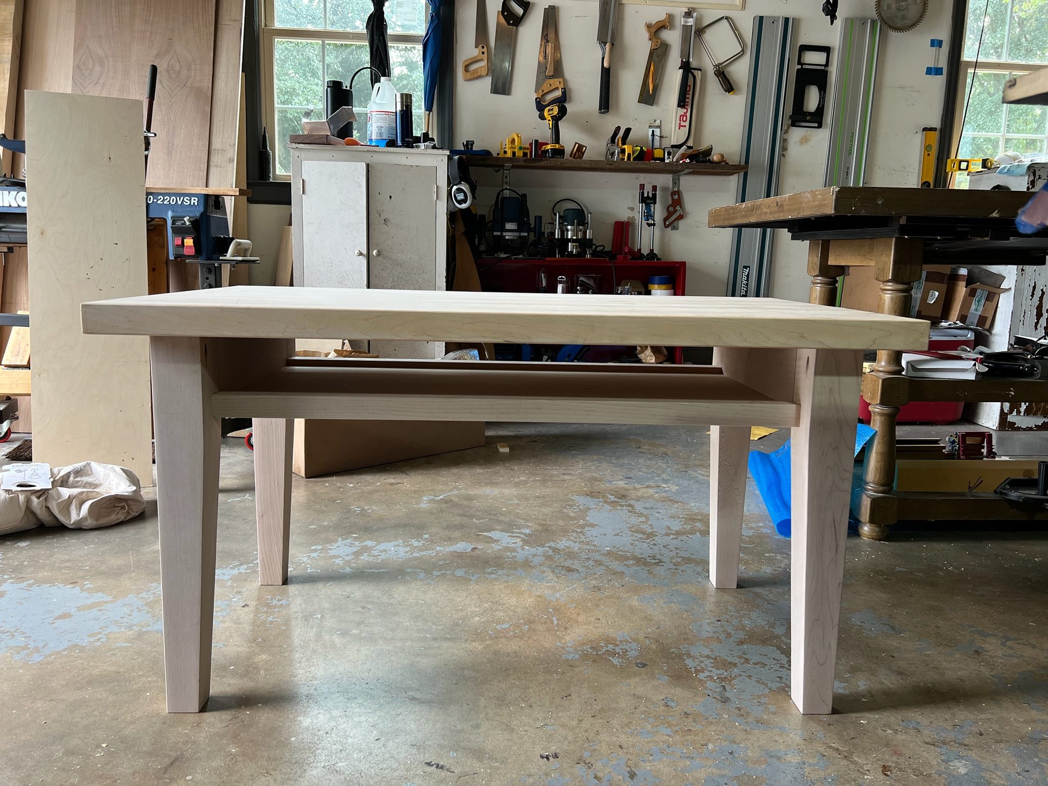 Natural maple dining table with slatted shelf