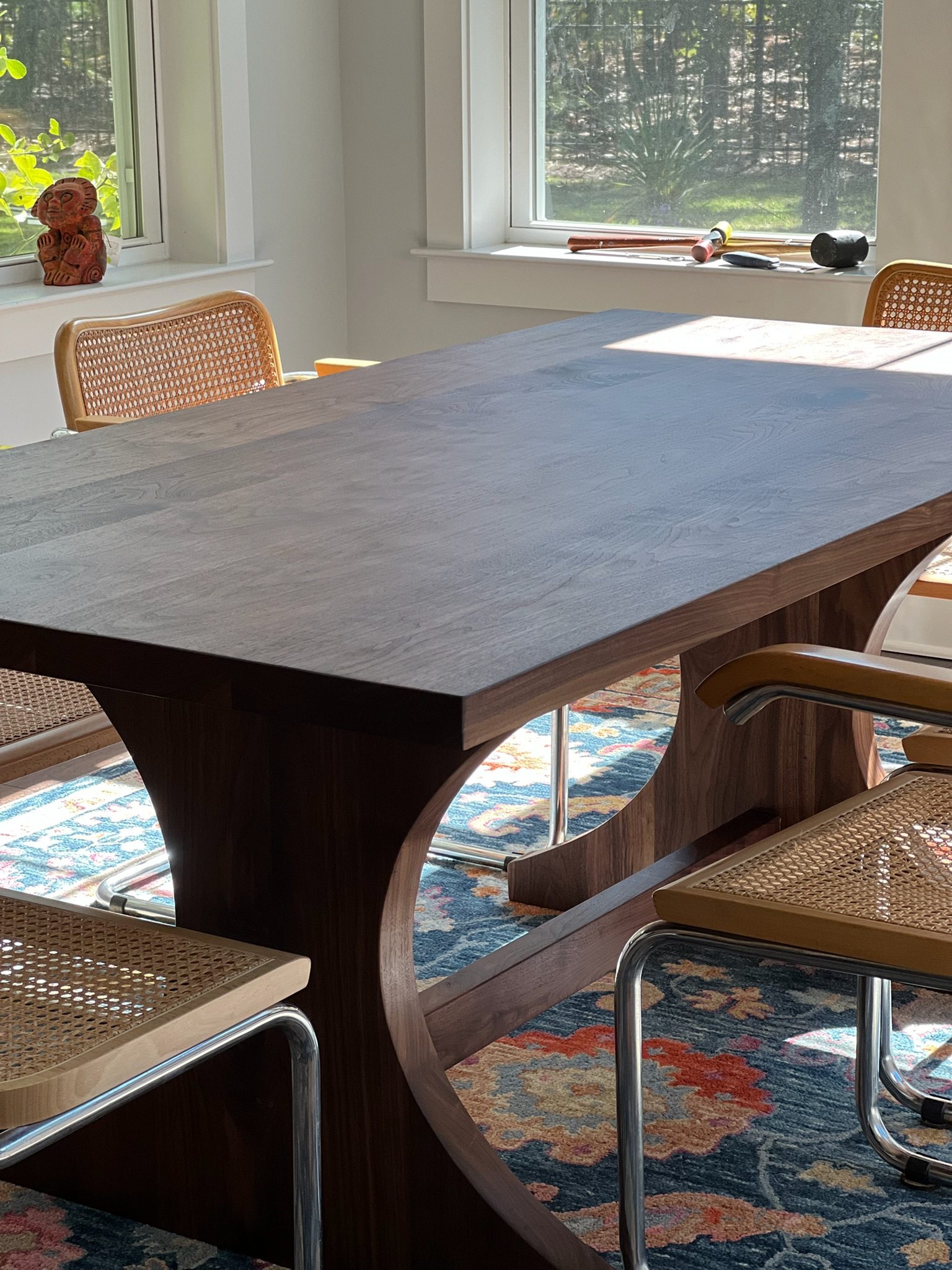Walnut dining table with sculptural arched base