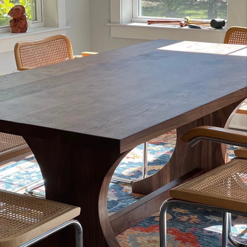 Sculptural solid walnut dining table